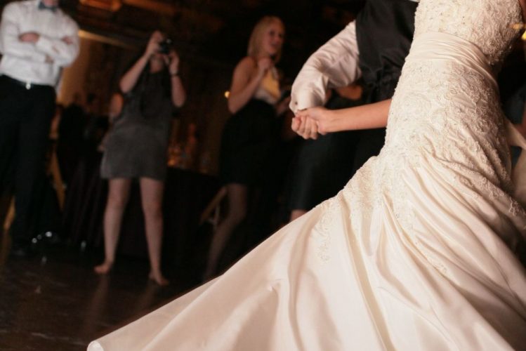 This couple is performing a dramatic dance at their wedding reception.