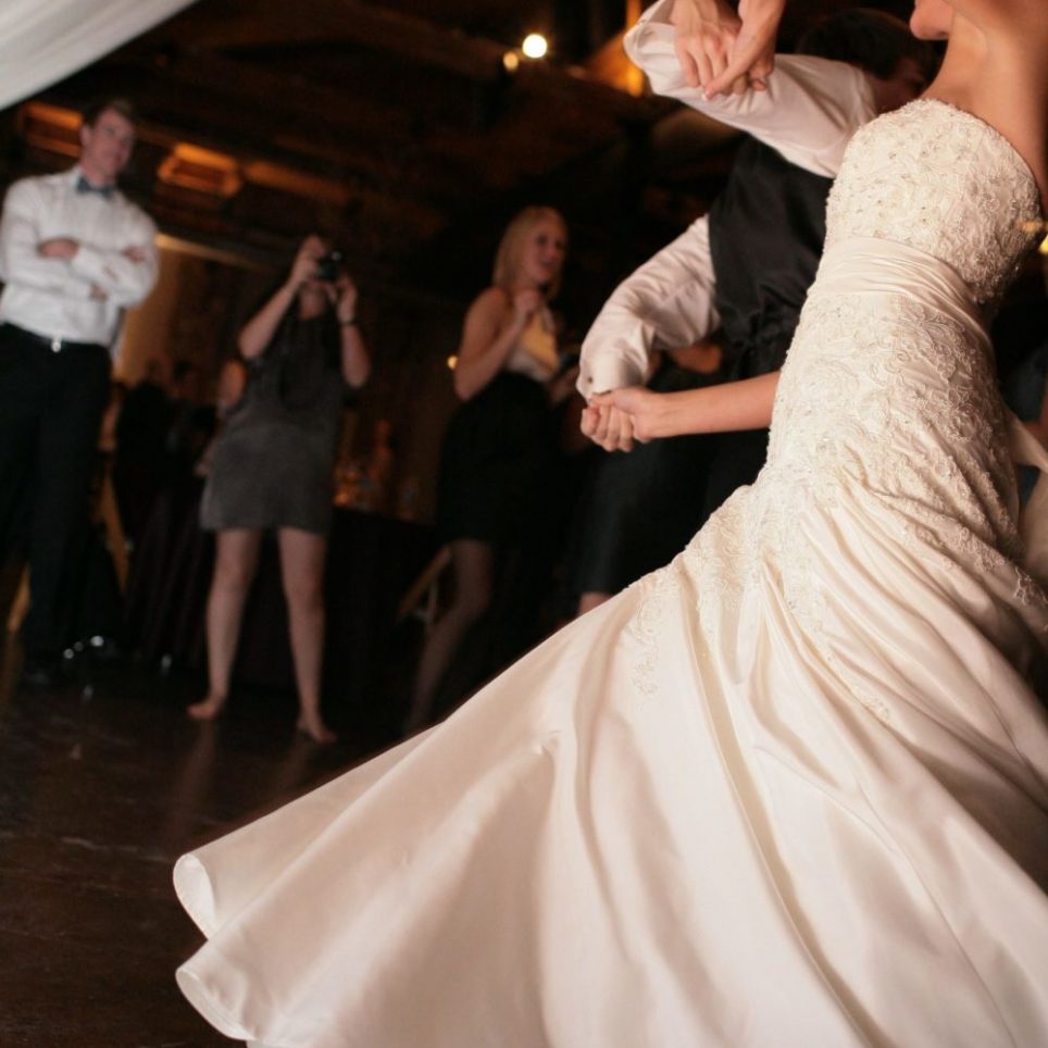 This couple is performing a dramatic dance at their wedding reception.