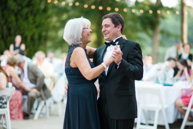 mother of the groom with groom dancing