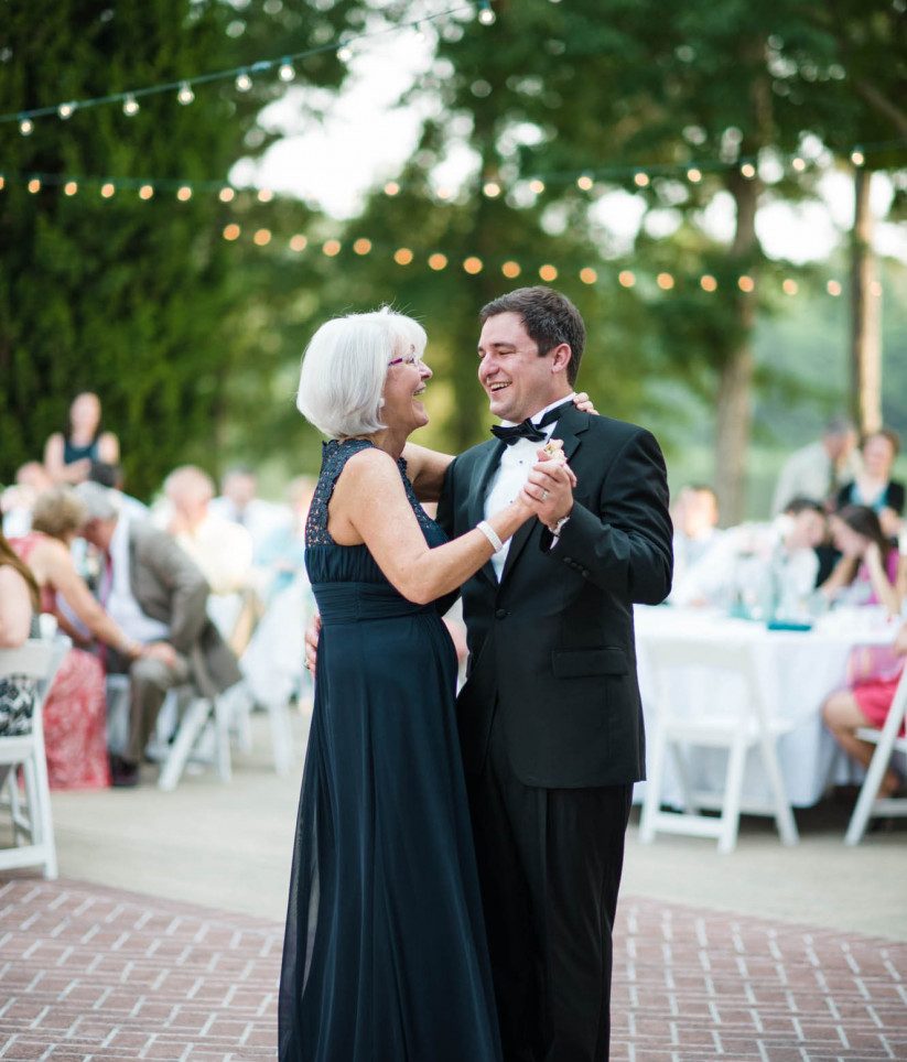 mother of the groom with groom dancing