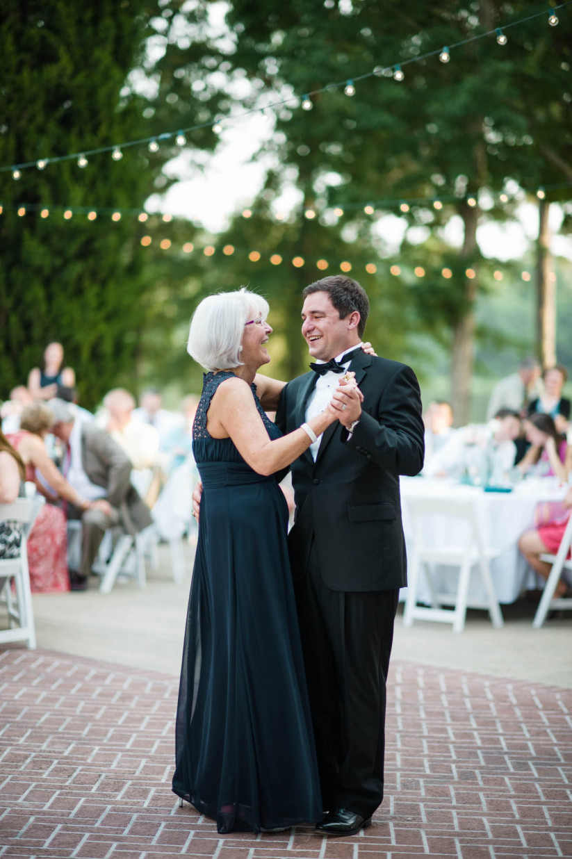 mother of the groom with groom dancing