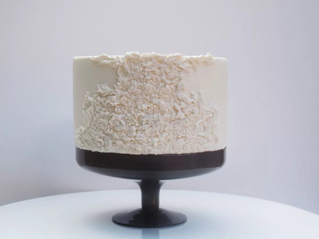 Classic buttercream wedding cake with decorative buttercream stenciling in a vintage design