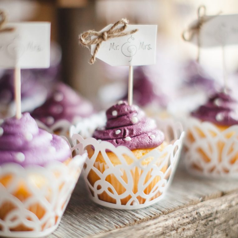 White cupcakes with purple frosting and white polka dots for weddings