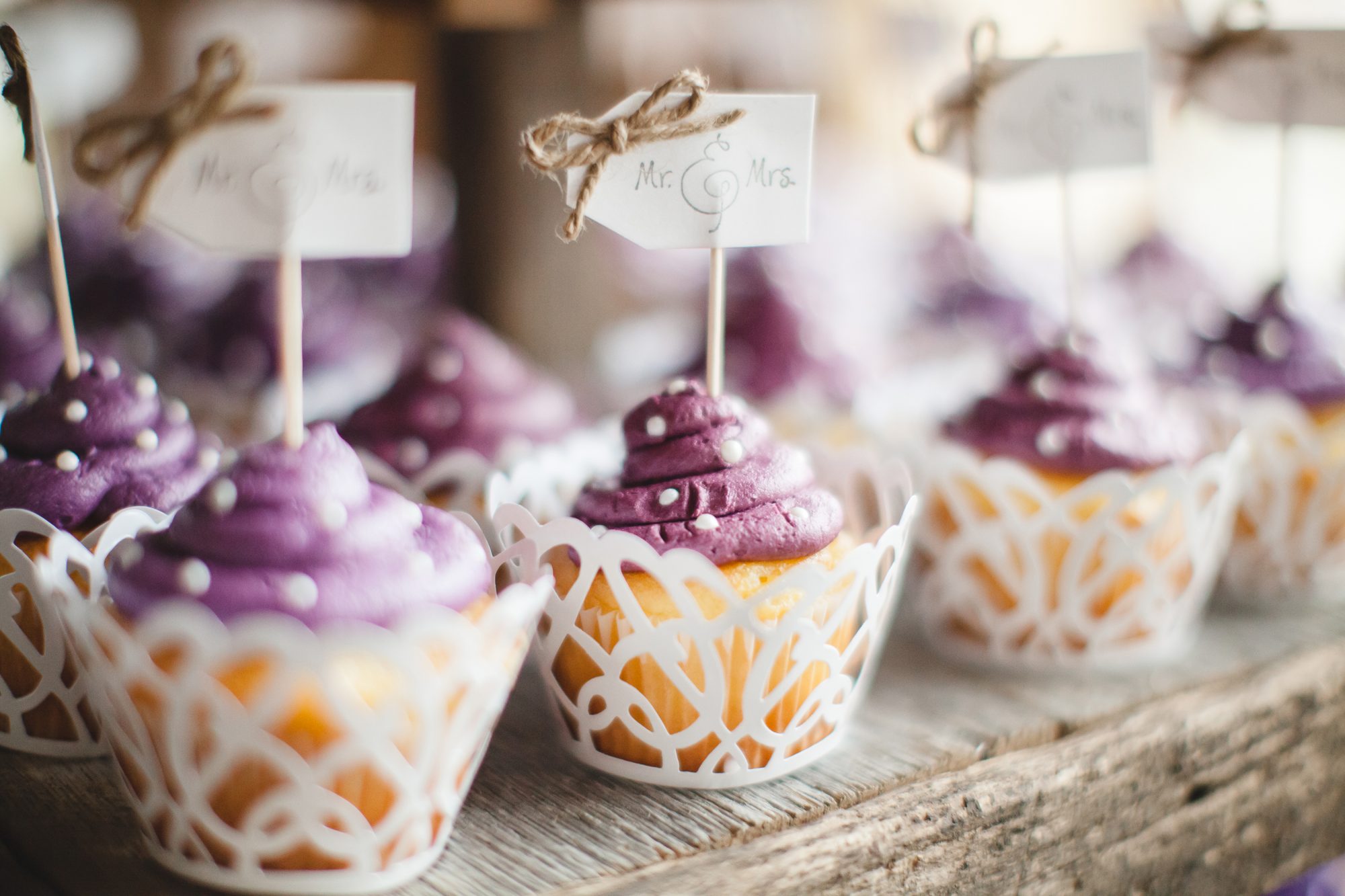 White cupcakes with purple frosting and white polka dots for weddings