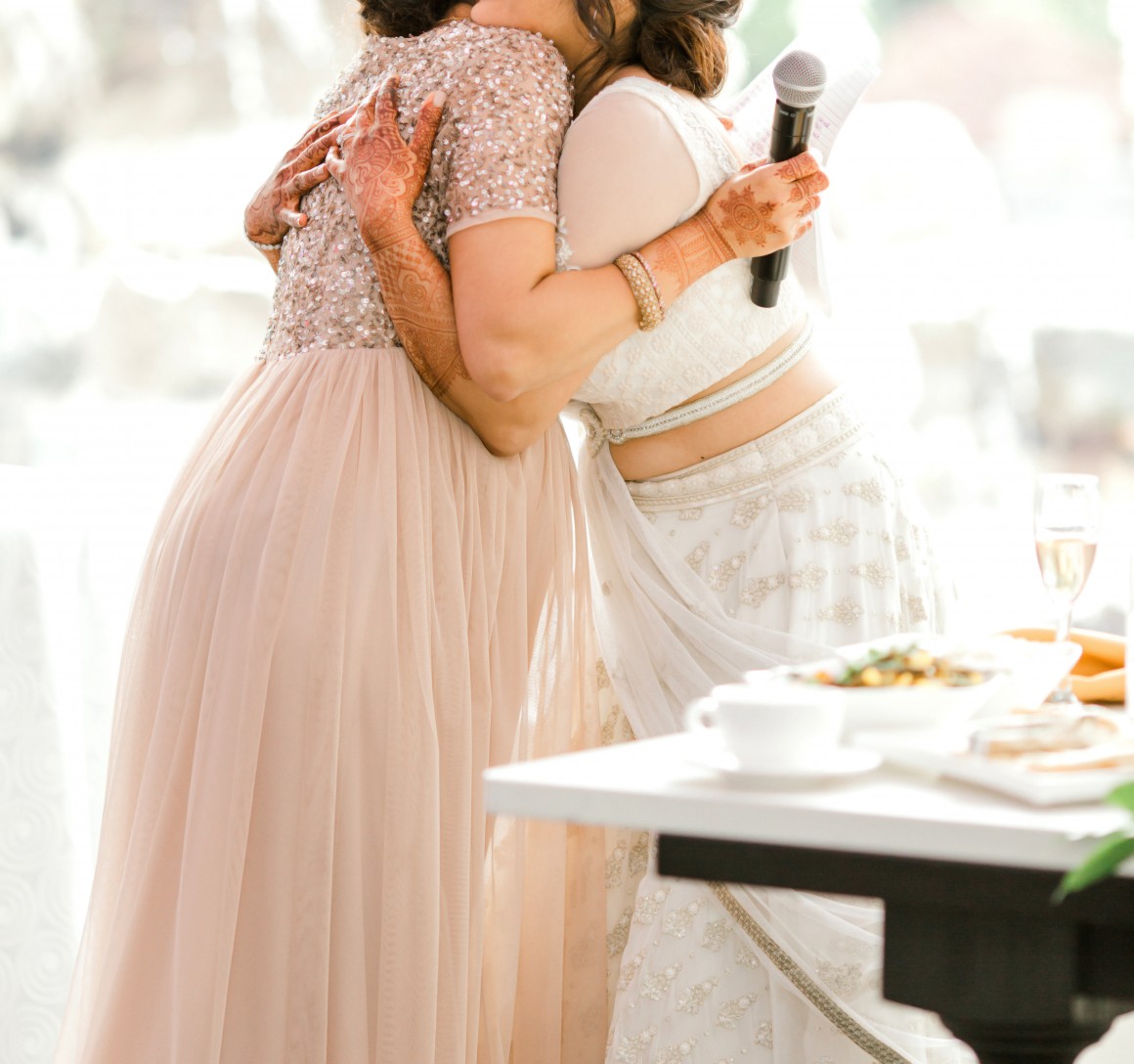 sister hugs bride after giving speech