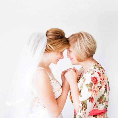 Mother embracing daughter at her wedding.