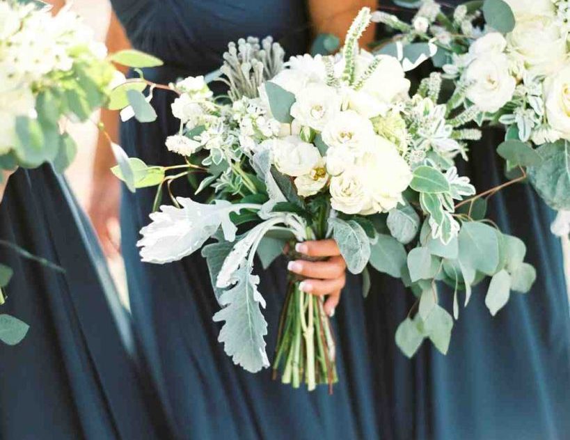 Bridesmaids holding intricate bouquets of flowers