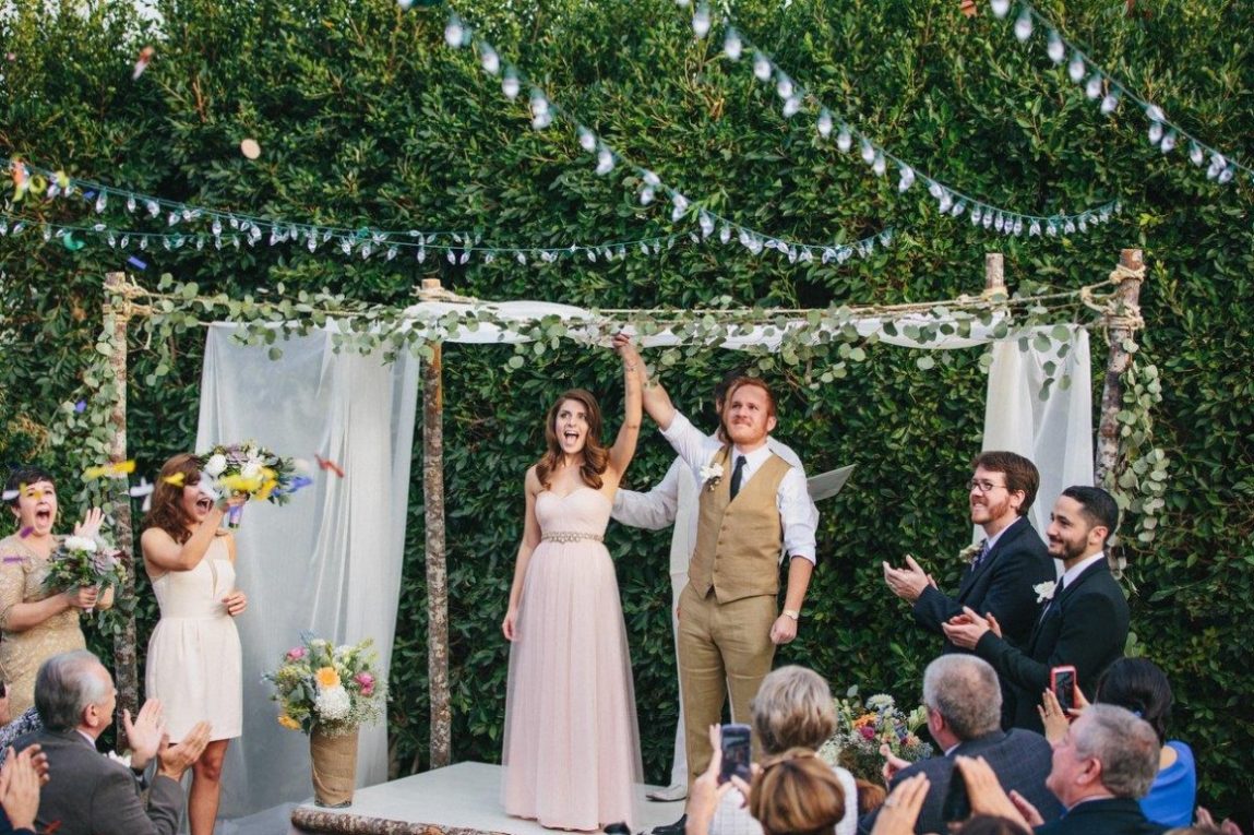 Bride and Groom getting married in a backyard wedding themed celebration