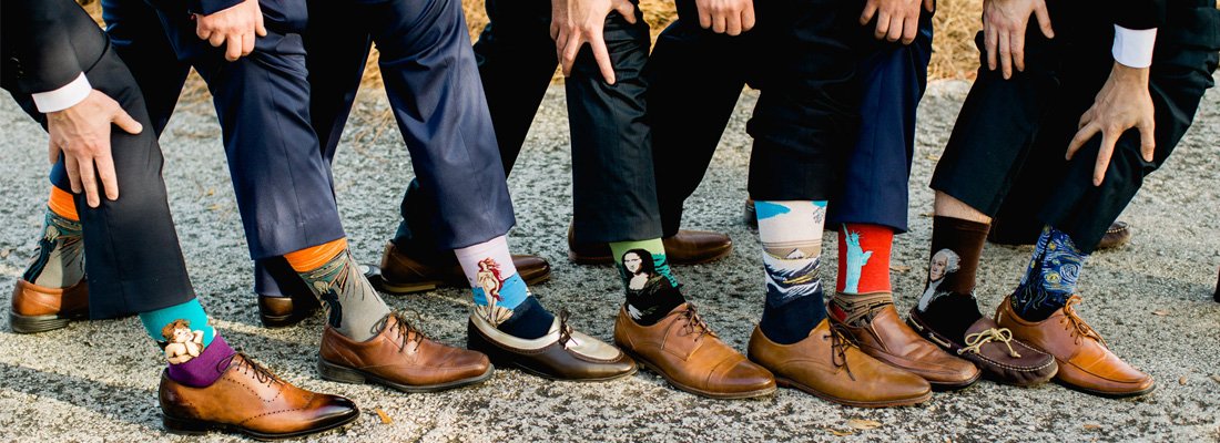 Set of groomsmen wearing socks with different famous paintings