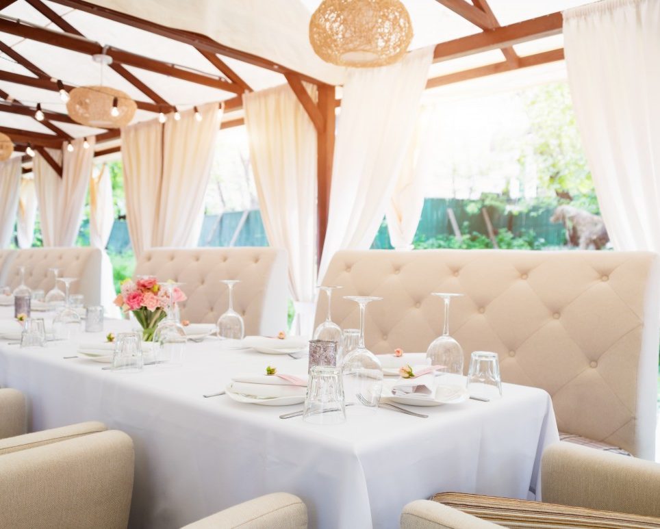 outdoor long table white white linen and ivory couches