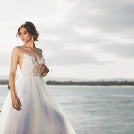 woman standing beside water in wedding dress