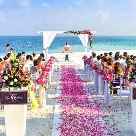 A wedding ceremony being held on a beach