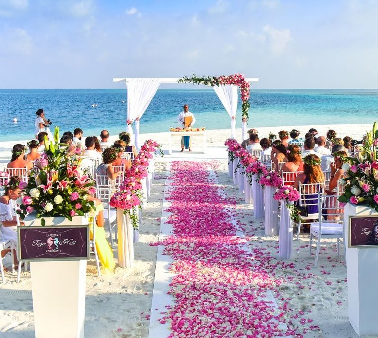 A wedding ceremony being held on a beach