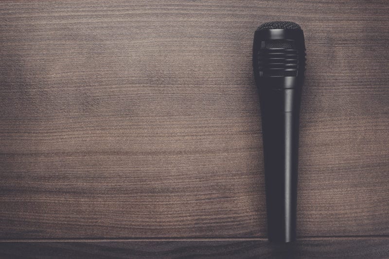 black mic on the brown wooden table