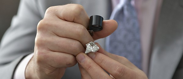 Appraiser looking at diamond jewelry to determine value