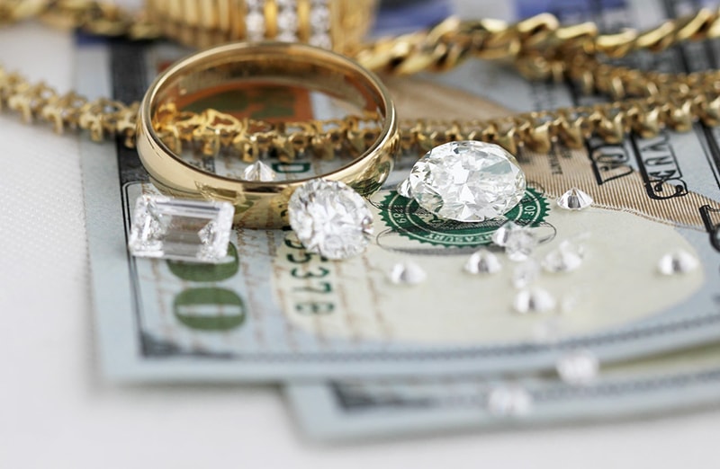 Diamond jewelry on pile of cash
