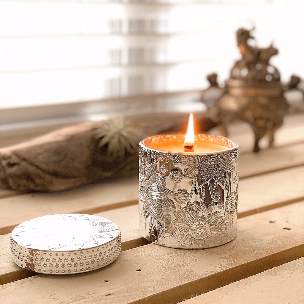 Spiral wooden luxury aromatherapy candle on wooden shelf near window