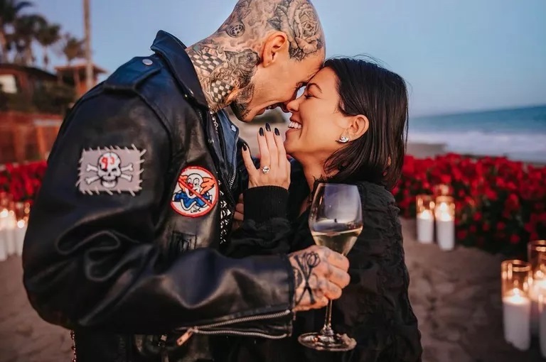 Kourtney Kardashian embracing with Travis Barker after getting engaged on the beach