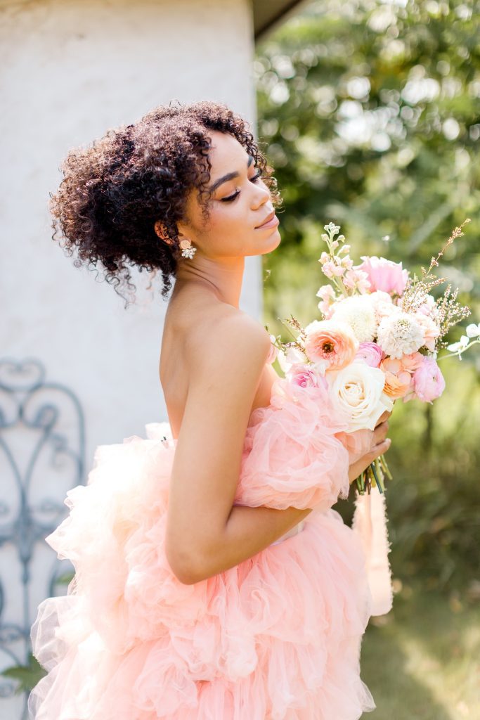 stunning bride wearing soft pastel gown in peach color