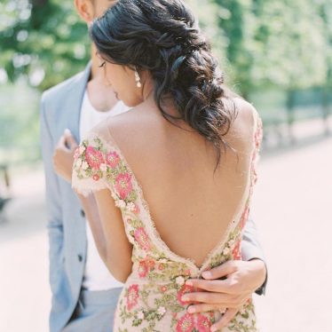 Bride wearing colorful floral wedding dress with low back