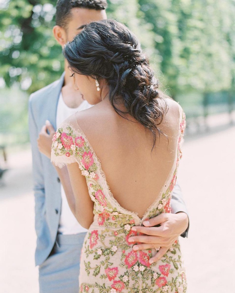 Bride wearing colorful floral wedding dress with low back