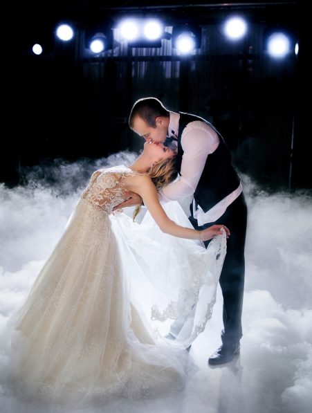 Couple performing move in smoke during first dance