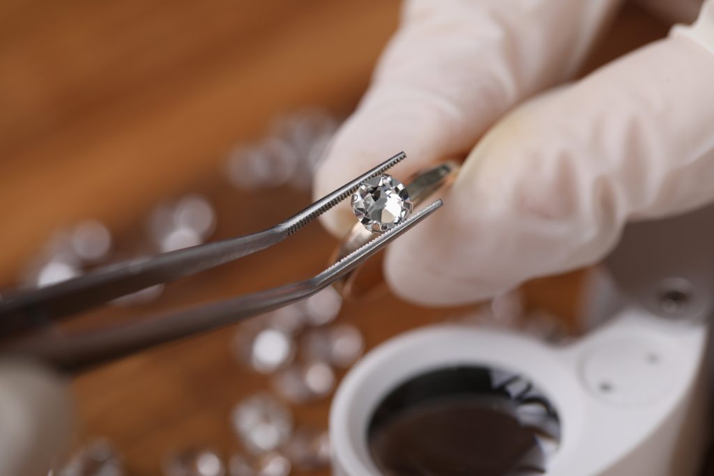 Holding a diamond with a set of tweezers