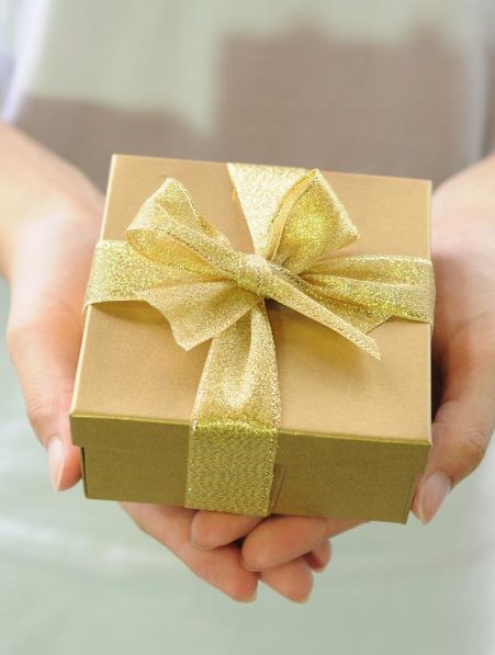 Hands holding a present box