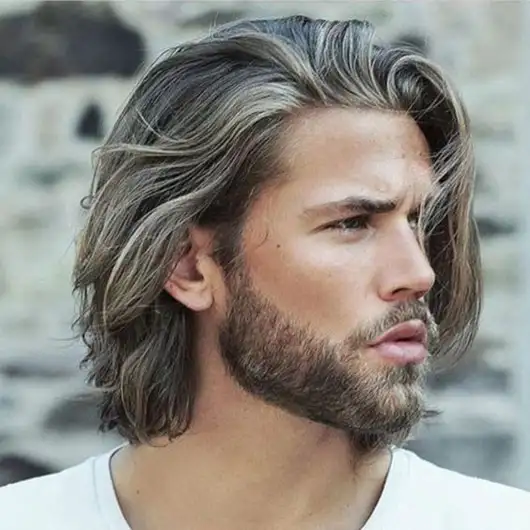 man with shoulder length wavy hair