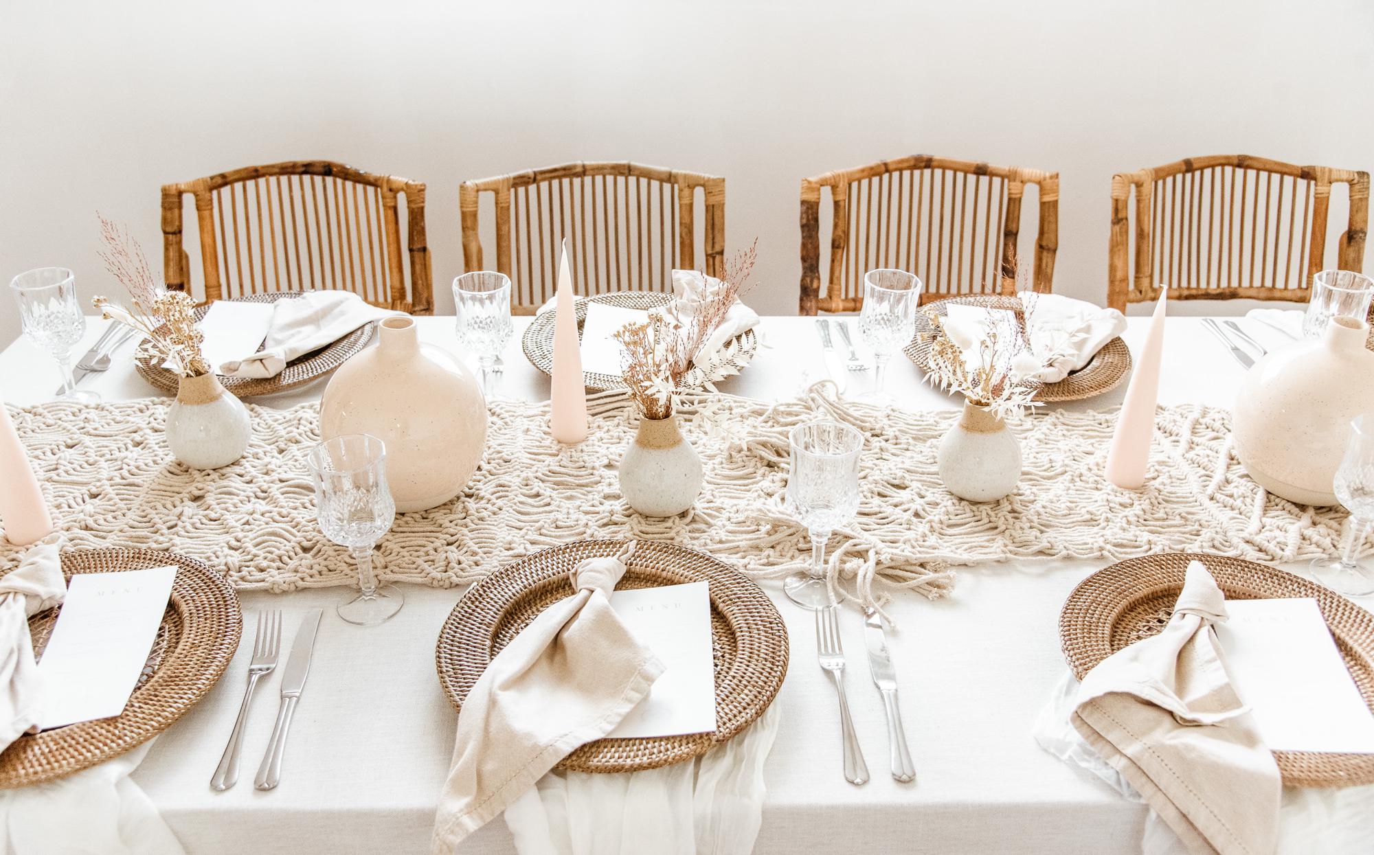 wedding reception table setup with ivory and champagne colored plateware