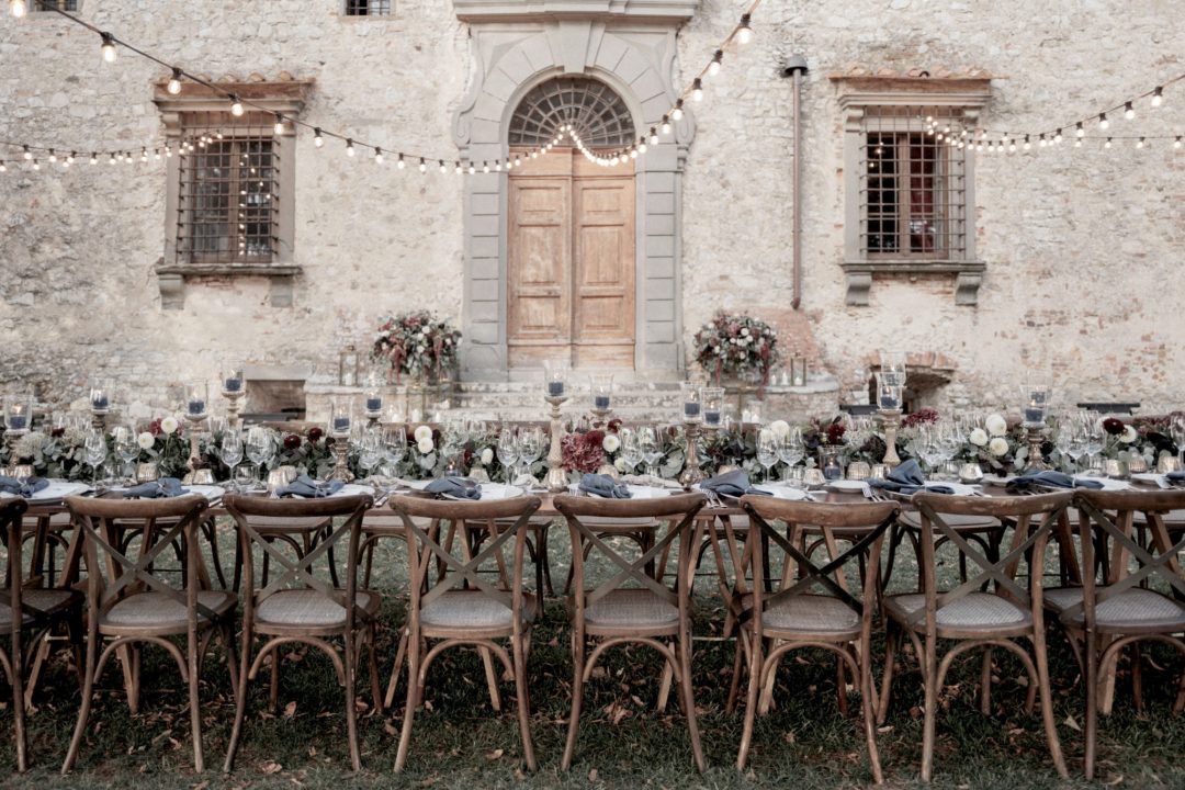 rustic outdoor dinner reception with lush greenery